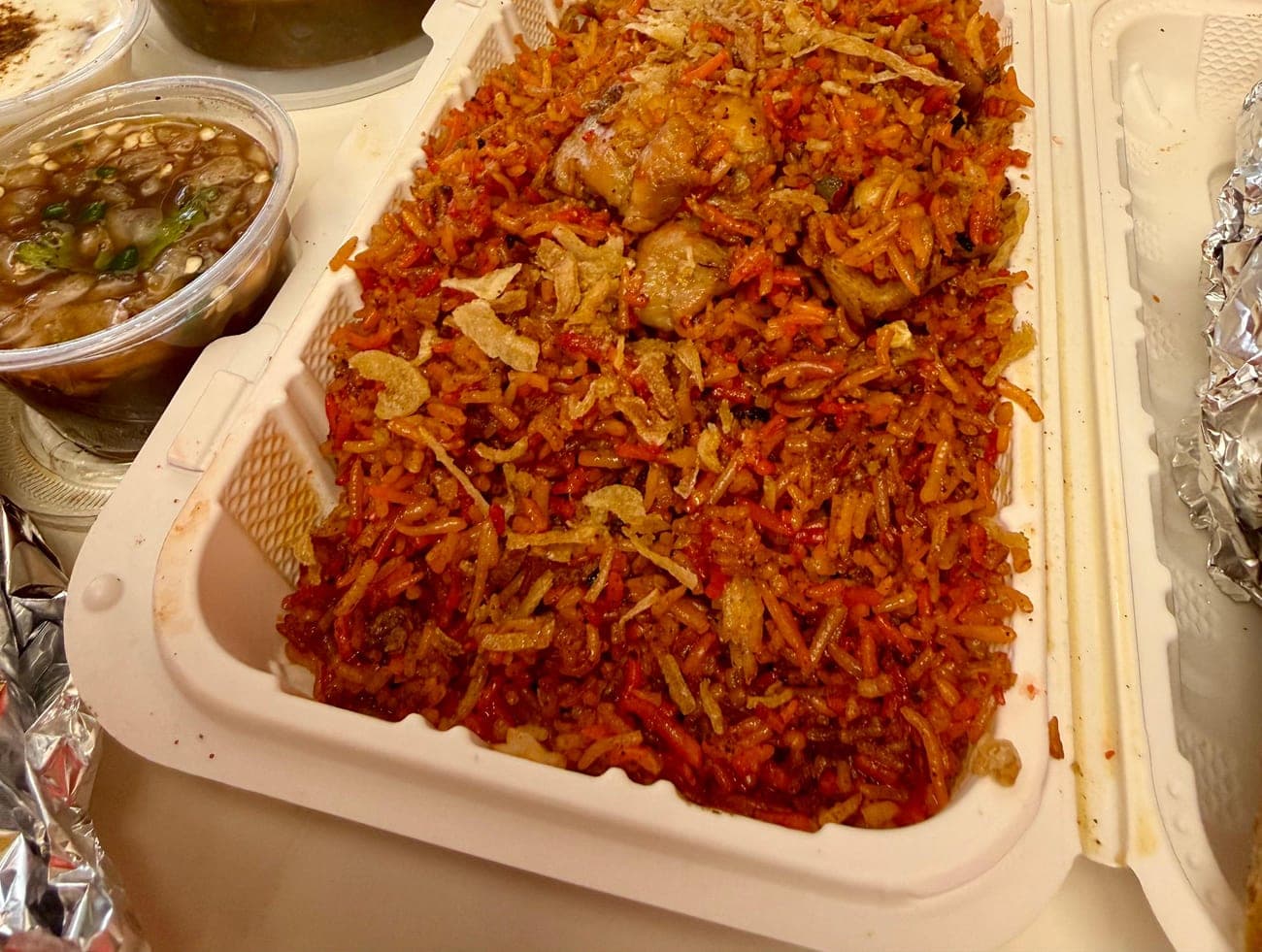 Boneless chicken biryani tray topped with crispy fried onions at IndiaWaale, North York