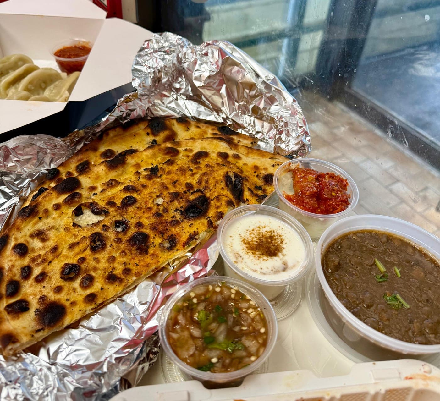 Amritsari kulcha — charred stuffed flatbread fresh off the tandoor at IndiaWaale