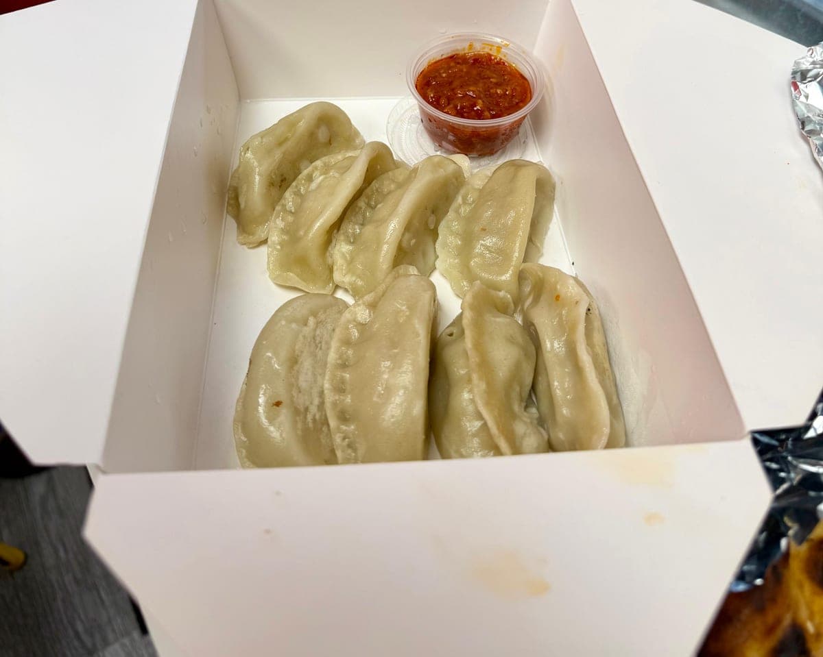 Steamed chicken momos served with spicy red chutney at IndiaWaale